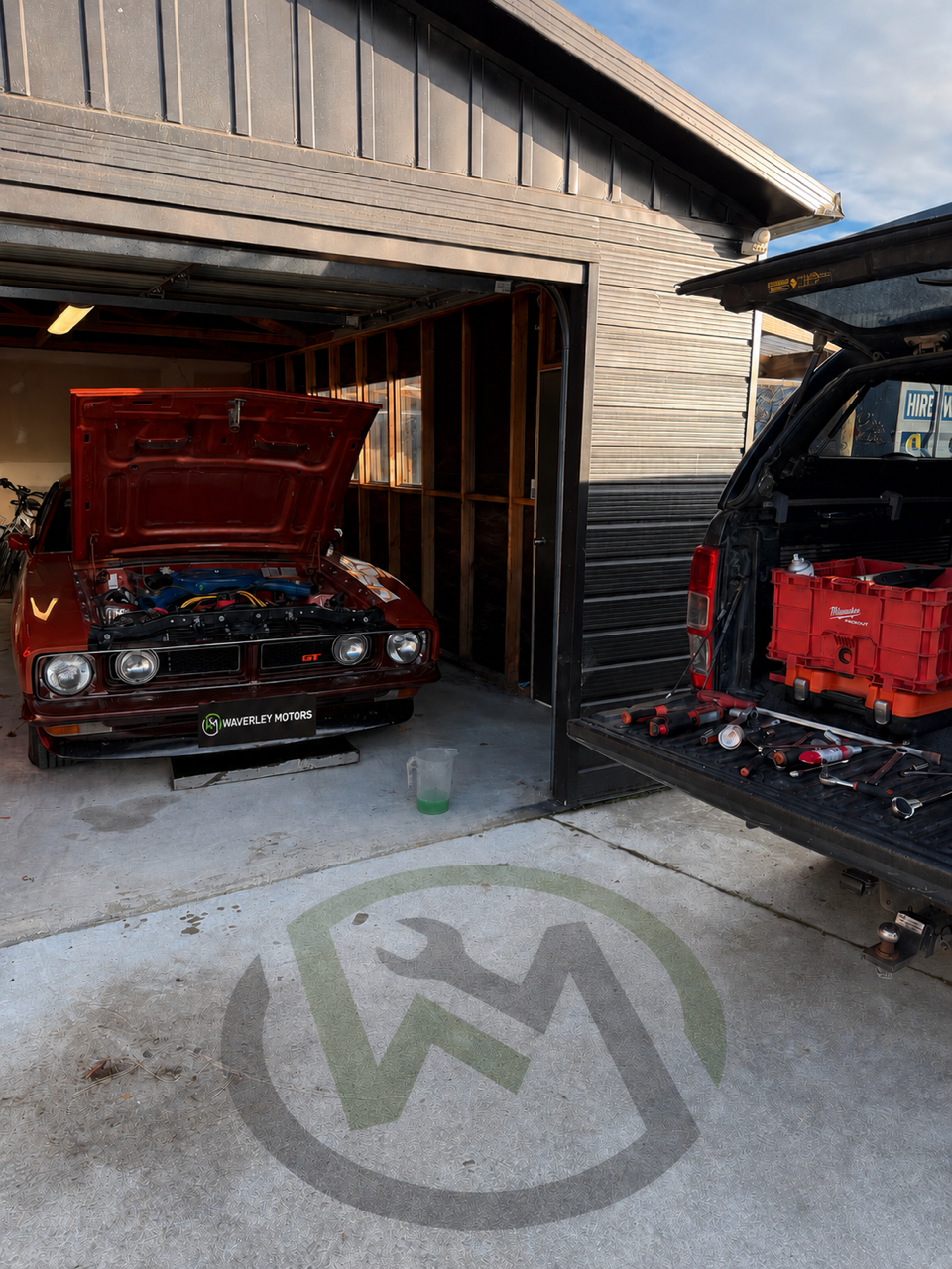 Classic Ford Falcon in the shed alongside a ute at Waverley Motors